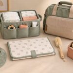 Practical baby-care essentials including diaper organiser, muslin cloths, changing mat and diaper bag