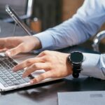 Person using a laptop to review job and skill-training options